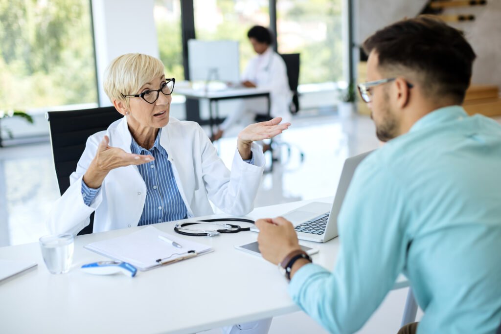 Doctor explaining health care options to a patient during a clinic consultation